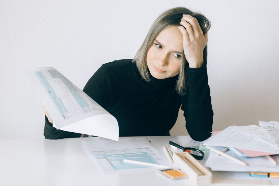A professional estate planner reviewing insurance documents with a client in a Hong Kong office setting